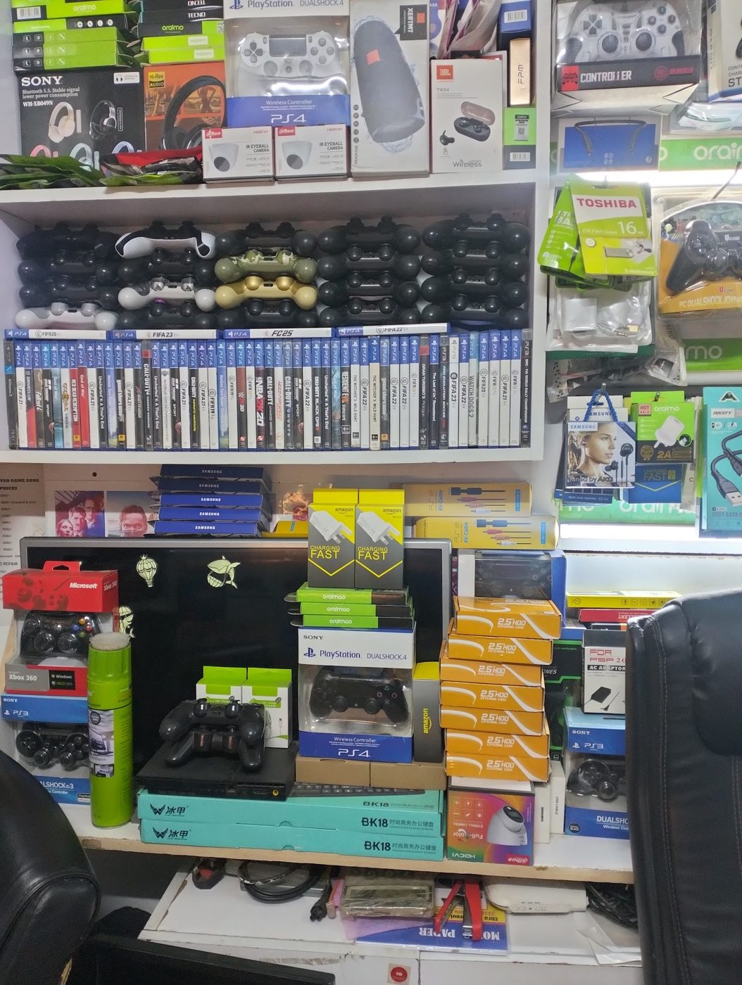 The wall of controllers, games and accessories at Shangtao Games, Baraka Plaza